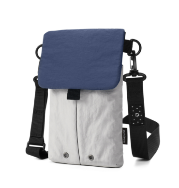 Lightweight nylon crossbody bag in khaki color with three pockets for everyday carry