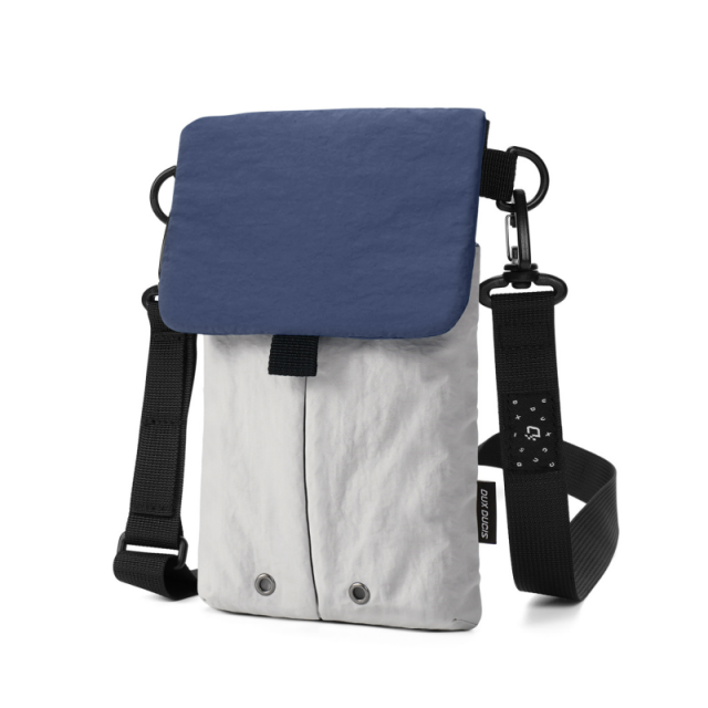 Lightweight nylon crossbody bag in khaki color with three pockets for everyday carry