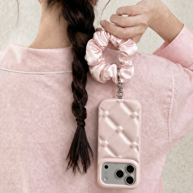 Wholesale satin scrunchie wrist strap attached to pink puffer phone case, 2-in-1 hair tie and lanyard for women, B2B aesthetic accessory.