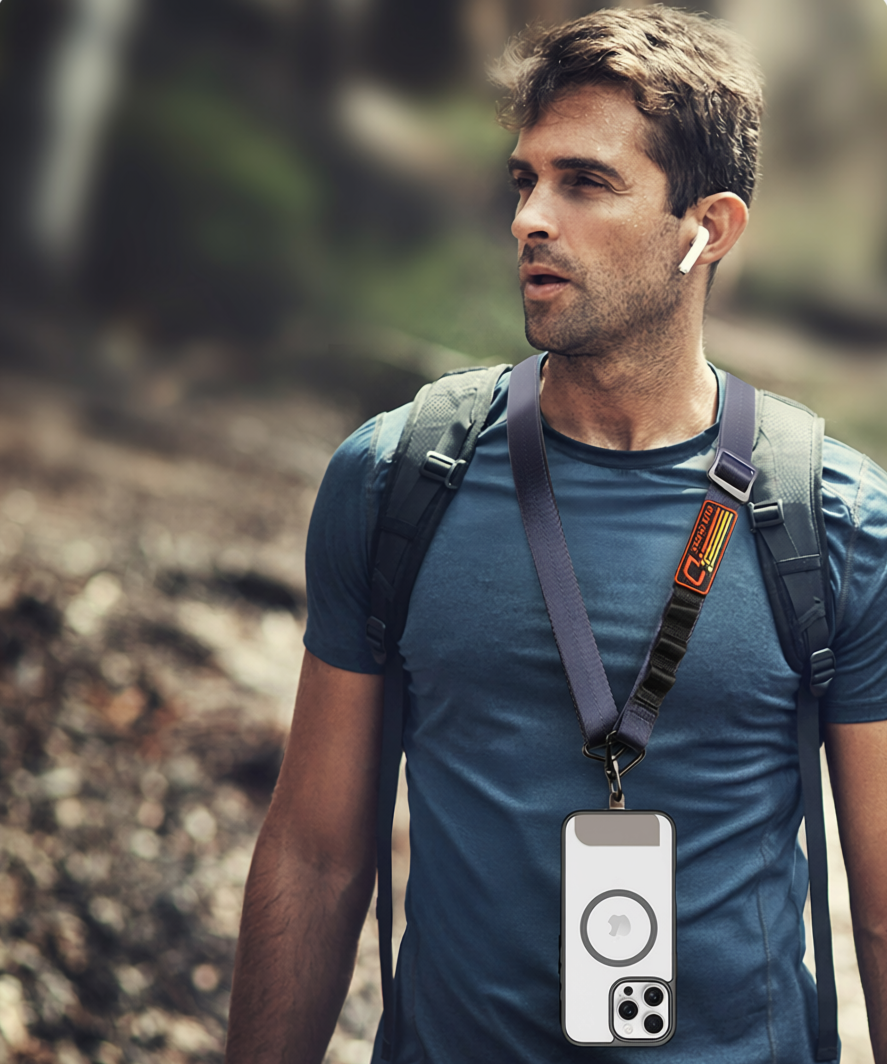 Outdoor lifestyle photo featuring a man wearing a crossbody lanyard with a transparent MagSafe phone case and earbuds, perfect for hands-free travel and daily outdoor activities.